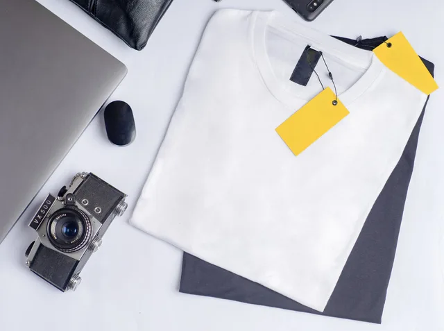 Stylish flat lay featuring a vintage camera, clothing, and laptop on a clean white background. Testing a product-specific page against a category page